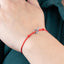 Pulsera hilo rojo broche t de corazon ajustable
