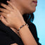 Pulsera de hilo ajustable con cruz perlas y balines 6mm